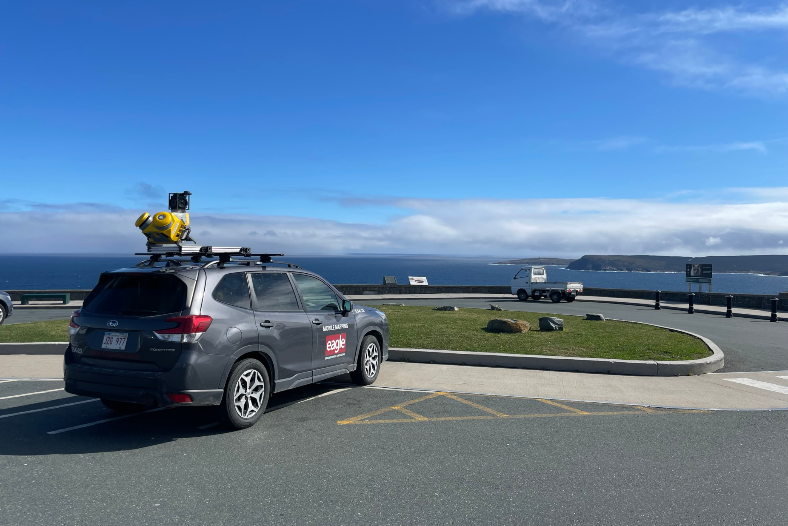 Eagle Engineering Subaru with Top Mounted camera, by a body of water.