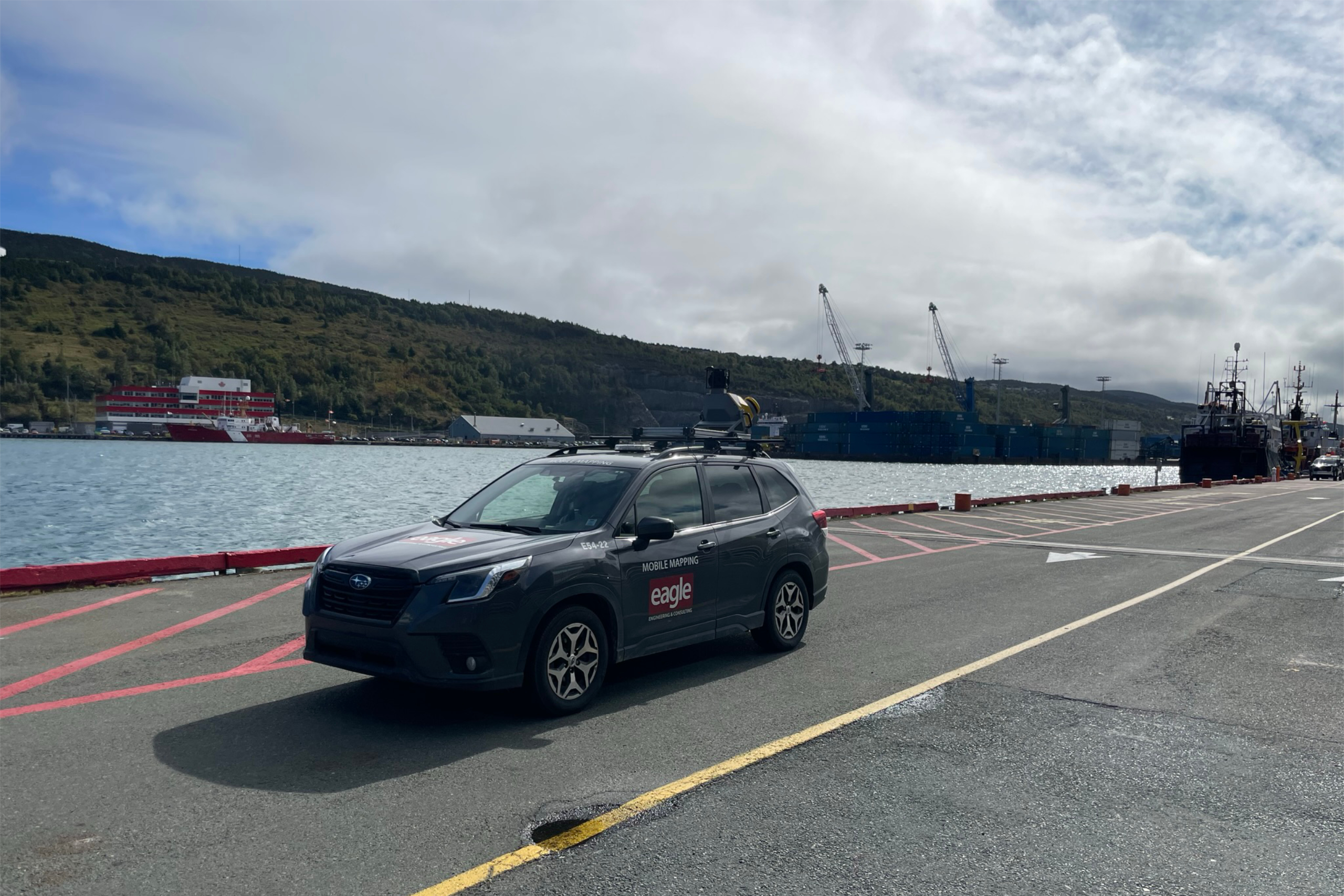 Eagle Engineering Subaru with Top Mounted camera, by a body of water.