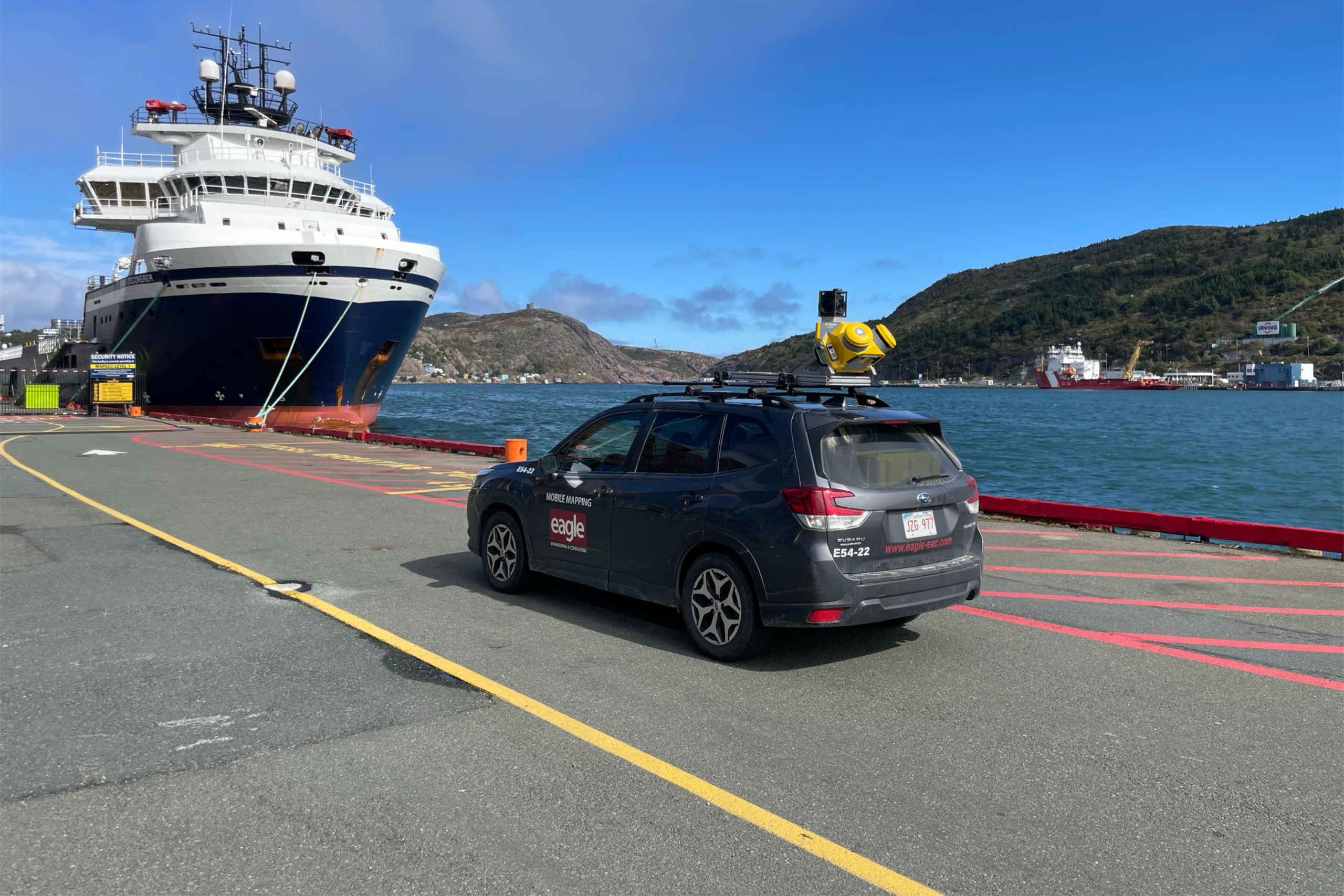 Eagle Engineering Subaru with Top Mounted camera, by a body of water.