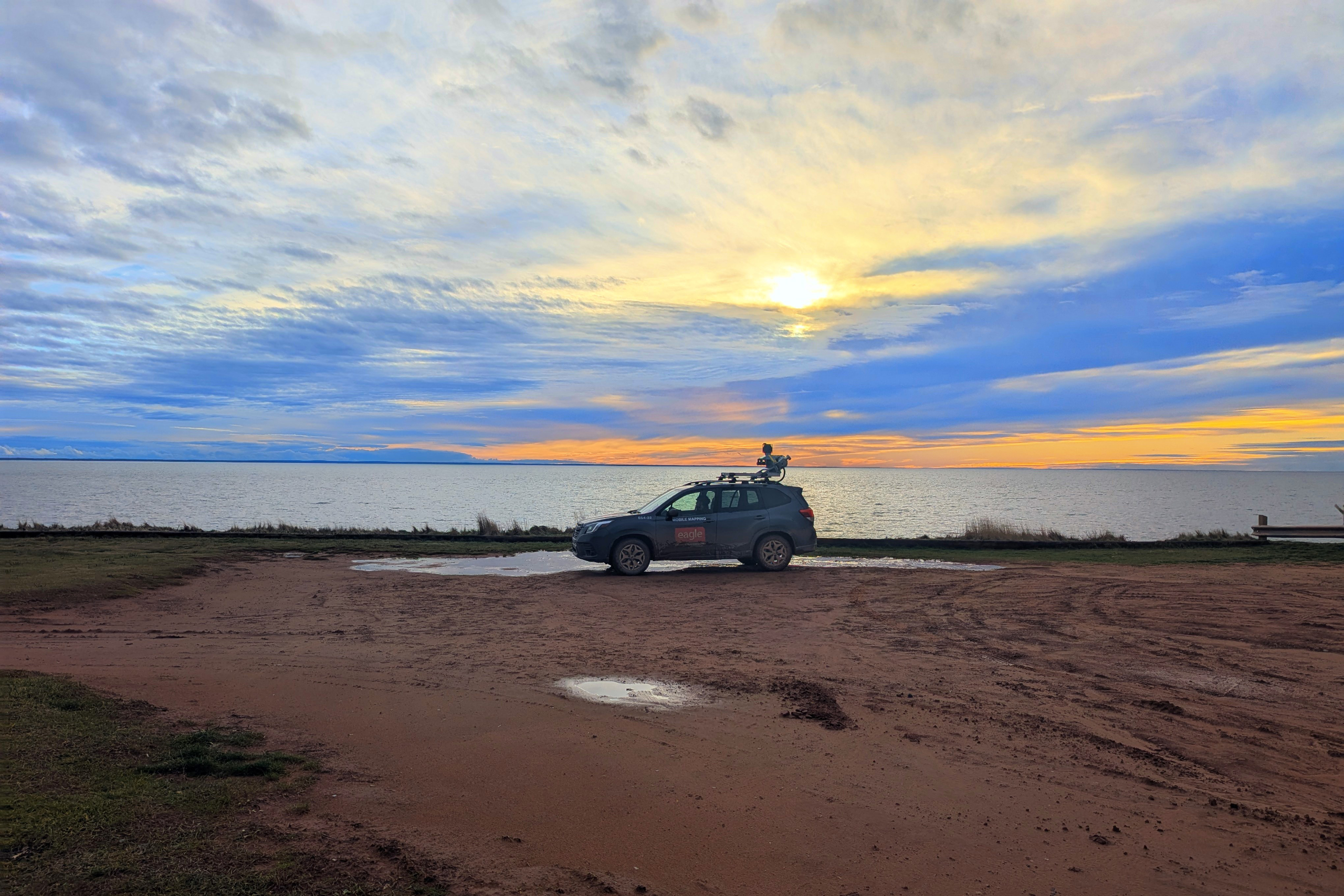 Eagle Engineering Subaru with Top Mounted camera, by a body of water.